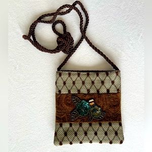 Handcrafted crossbody shoulder bag made from assorted fabrics and sequin trim.
